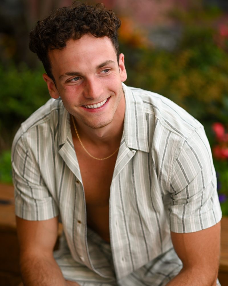 Cole Blanco — portrait, smiling, in a striped shirt outdoors